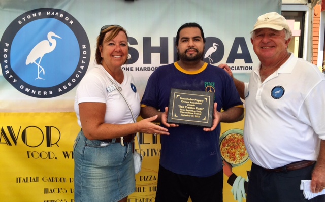 Peace of Pizza General Manager Jonathon Mendoza is congratulated by SHPOA Trustees Rose Clay and Ed Geiger